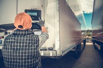 Man die de temperatuur van zijn koelwagen aanpast